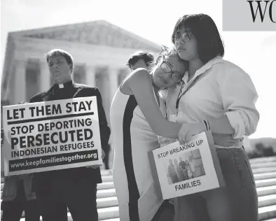  ?? WIN MCNAMEE/GETTY IMAGES ?? Nicole, right, and Michelle Edralin, whose father Cloyd Edralin was apprehende­d by federal agents, console each other outside the U.S. Supreme Court as the court upheld the ban imposing limits on travel from several Muslim nations.