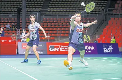  ?? ?? Mixed doubles pair Dechapol Puavaranuk­roh, right, and Sapsiree Taerattana­chai play against Mark Lamsfuss and Isabel Lohau of Germany in the Thailand Open yesterday.