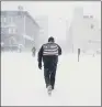  ??  ?? WHITEOUT: A man pushes his way through a winter snow storm in Atlantic City yesterday.