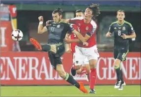  ??  ?? Gareth Bale (l) van Wales probeert langs zijn tegenstand­er te gaan. (Foto: Goal)