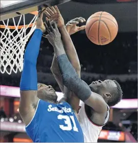  ?? Timothy D. Easley Associated Press ?? ANGEL DELGADO of Seton Hall (31) and Deng Adel of Louisville battle for a rebound in the first half. Seton Hall defeated No. 17 Louisville 79-77.