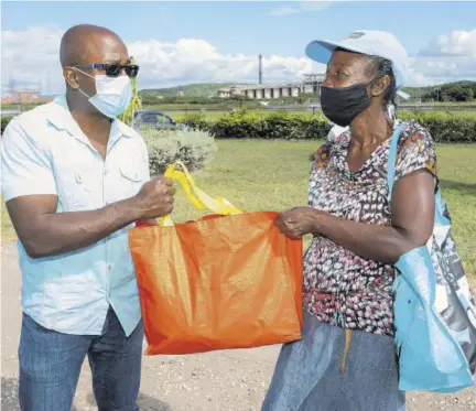  ??  ?? Pearnel Charles Jr, Member of Parliament for Clarendon South-eastern, was on the ground assisting New Fortress Energy Foundation and Food For the Poor with handing out packages to families in the Port and Refinery Council communitie­s in Hayes, Clarendon, recently.