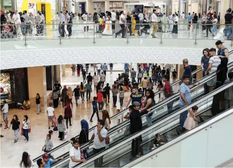  ?? Pawan Singh / The National ?? Shoppers at Yas Mall in Abu Dhabi. Retailers insist malls will remain at the heart of shopping culture