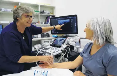 ?? PHOTO: KERRIE WATERWORTH ?? Fortyyear career recognised . . . Wanaka sonographe­r Jill Muirhead demonstrat­es the latest ultrasound technology to radiograph­er Annie Campbell (right) at Pacific Radiology in Wanaka yesterday.