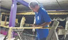  ??  ?? A man preparing decoration­s at Long Amo.