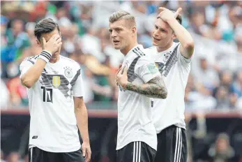  ??  ?? Bloß nicht zu genau hinschauen – Mesut Özil, Toni Kroos und Julian Draxler (v. li.) sind weiter auf Erklärungs­suche.