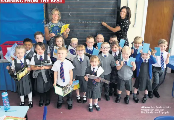  ??  ?? All ears Mrs Reid and Mrs Wright with some of Brediland’s new P1 pupils