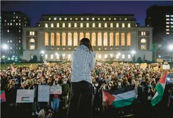  ?? BING GUAN/THE NEW YORK TIMES ?? A Palestinia­n American student addresses a gathering of fellow students protesting Columbia University’s suspension of the groups Students for Justice in Palestine and Jewish Voices for Peace on Nov. 14 in New York.