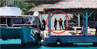  ??  ?? Caught on camera: FBI agents disembark on a jetty at Little St James yesterday