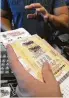  ?? AFP / Getty Images ?? California sold 200 Mega Millions tickets a second Thursday.