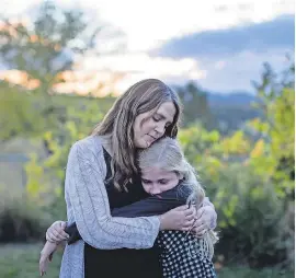  ?? PHOTOS BY KRISTINA BARKER ?? Kristen Kilmer, diagnosed with incurable breast cancer three years ago, hugs her daughter at their home in Spearfish, S.D.