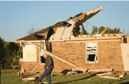  ?? LM OTERO/AP ?? A man searches on Saturday in Powderly, Texas, for the eyeglasses he had dropped the night before in front of his daughter’s home, which was destroyed by a tornado.