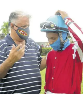  ?? (Photo: Garfield Robinson) ?? Jockey Anthony Thomas (right) and trainer Wayne Dacosta