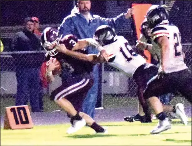  ?? Westside Eagle Observer/MIKE ECKELS ?? Gentry’s Peyton Wright (3) fights his way toward the end zone as Pea Ridge’s Justin Koon (16) latches on to bring Wright down around the 6-yard line during the third quarter in Gentry on Sept. 21. The Pioneers moved the ball to the 1-yard line before penalties and the Blackhawk defense pushed them back.