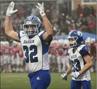  ?? Erik Trautmann / Hearst Connecticu­t Media ?? Darien’s Tighe Cummiskey (32) celebrates a touchdown in the Class LL state championsh­ip game against Fairfield Prep in December.