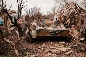  ?? Nicole Tung / New York Times ?? A Russian military vehicle lies amidst debris in the heavily destroyed village of Oleksandri­vka, Ukraine, on Jan. 26.
