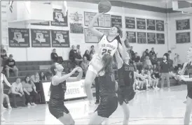  ?? Photo by Becky Polaski ?? Though under pressure from a trio of Clarion players, Sydney Alexander, 25, was able to score two of her 15 points on this play in the second half of Thursday’s game.