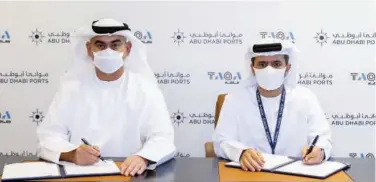  ??  ?? ↑
Taqa Group and Abu Dhabi Ports officials signing the agreement.