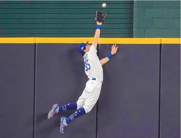  ?? SUE OGROCKI/ASSOCIATED PRESS ?? The Dodgers’ Cody Bellinger leaps to rob the Padres’ Fernando Tatis Jr. of a two-run homer in the seventh inning of Game 2 of their series Wednesday night. The catch preserved LA’s lead at 4-3.
