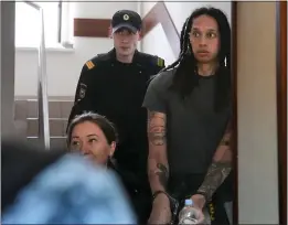  ?? ALEXANDER ZEMLIANICH­ENKO – THE ASSOCIATED PRESS ?? WNBA star and two-time Olympic gold medalist Brittney Griner is escorted to a courtroom for a hearing in Khimki just outside Moscow on June 27.