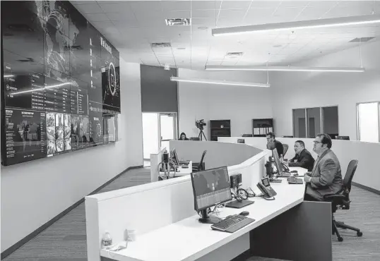  ?? Josie Norris/Staff photograph­er ?? Team members work in the Alamo Regional Security Operations Center at Port San Antonio in December.