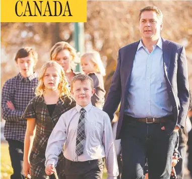  ?? GEOFF ROBINS / AFP VIA GETTY IMAGES ?? Conservati­ve Leader Andrew Scheer arrives with his family to vote at a polling station in his home riding of Regina—qu’appelle, Sask., on election day Oct. 21. Scheer’s inability to win the election against the Liberals led by a damaged Justin Trudeau had sparked calls for his resignatio­n, which he announced on Thursday.