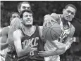  ?? AP Photo/Tony Dejak ?? ■ Oklahoma City Thunder’s Alex Abrines, left, and Cleveland Cavaliers’ Jordan Clarkson compete for a loose ball Wednesday in Cleveland.