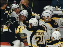  ?? ALEX BRANDON — THE ASSOCIATED PRESS ?? Brad Marchand, left, celebrates with his Bruins teammates after scoring the winning goal against the Capitals in overtime of Game 2 on Monday.