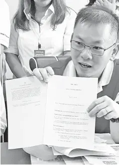  ??  ?? Chan holding the Constituti­on Amendment 2019 Bill during a press conference held yesterday.