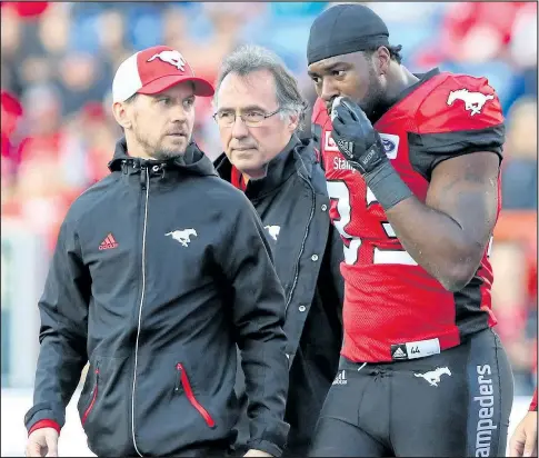  ?? GAVIN YOUNG/POSTMEDIA ?? Stamps running back Jerome Messam walks off the field following a helmet-to-helmet hit last weekend at McMahon Stadium.