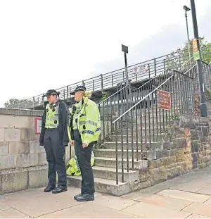  ?? Police officers at the railway bridge on Tay Street. Picture: Stuart Cowper. ??