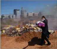  ??  ?? An ultra-orthodox Jew burns leavened items collected from across Bnei Brak, Israel, in preparatio­n for the Passover holiday