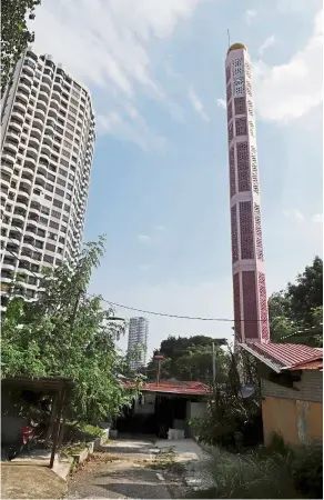 ??  ?? Steeped in history: Masjid Jamek Batu Uban is located at the centre of a land reclamatio­n project, coastal highway and high condominiu­ms in Gelugor. — LIM BENG TATT/The Star