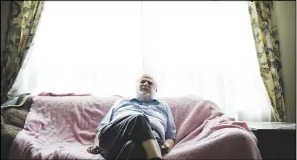  ?? CP photo ?? John Rae poses for a photograph at his home in Toronto. Rae is one of many advocates eagerly awaiting the release of Canadas first federal legislatio­n geared toward removing barriers for people with disabiliti­es.