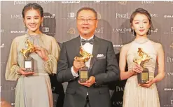  ??  ?? Chinese actress Zhou Dongyu, from right, actor Fan Wei and actress Ma Sichun hold their award for Best Leading Actress and Actor at the 53rd Golden Horse Awards in Taipei, Taiwan, Saturday. — AP photos