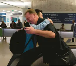  ?? JAE C. HONG/AP ?? Michael White, right, a Navy veteran jailed in Iran for several years, hugs former fellow prisoner Mahdi Vatankhah on June 1 at Los Angeles Internatio­nal Airport.