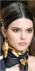  ??  ?? Go for gold: Kendall Jenner models Versace hair pins
