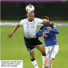  ??  ?? Swansea’s Andre Ayew beats Cardiff’s Ciaron Brown to a header