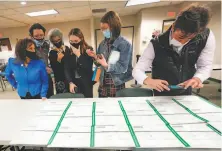  ?? Mary Altaffer / Associated Press ?? Democratic and Republican observers inspect Lehigh County provisiona­l ballots in Allentown, Pa.