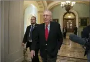  ?? J. SCOTT APPLEWHITE — THE ASSOCIATED PRESS ?? Senate Majority Leader Mitch McConnell, R-Kentucky, walks from the chamber to his office as the GOP overhaul of the tax bill nears a vote on Capitol Hill in Washington .