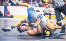  ?? ROBERTO E. ROSALES/JOURNAL ?? Manzano’s Isaac Garcia, bottom, spins Santa Fe’s Isaac Beltran during their 120-pound matchup Saturday. Garcia won the match 6-5 to earn a state championsh­ip.