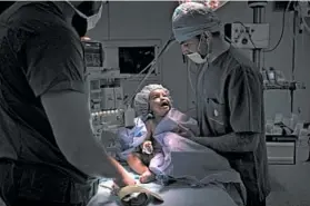  ?? FELIPE DANA/AP ?? Yazan, 1, cries before surgery at Tajoura National Heart Center in Tripoli. An internatio­nal team of experts regularly flies into Libya to perform surgery on patients like Yazan.