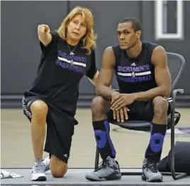  ?? AP PHOTO/RICH PEDRONCELL­I ?? Nancy Lieberman, an assistant for the Sacramento Kings at the time, talks with guard Rajon Rondo during a training camp workout on Oct. 26, 2015. She was a college star at Old Dominion from 1976 to 1980 and played in the WNBA when that league began in 1997, having already played profession­ally in other leagues.