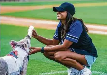  ?? Richard Tsong-Taatarii / Minneapoli­s Star Tribune ?? “The Bacheloret­te” star Michelle Young feeds mascot Space Ham at a St. Paul Saints baseball game in Minnesota. The show will introduce Clayton Echard, who may be the next bachelor.