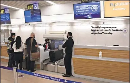  ??  ?? Security keeps an eye on travelers at Israel’s Ben Gurion Airport on Thursday.