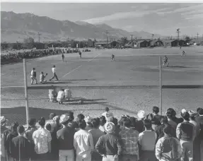  ?? PHOTOS PROVIDED BY ANSEL ADAMS VIA LIBRARY OF CONGRESS ?? Ansel Adams captured an amateur baseball game at the Japanese-American mass incarcerat­ion camp.
