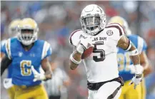  ?? Danny Moloshok / Associated Press ?? Trayveon Williams runs for a 61-yard touchdown in the first half for Texas A&amp;M, which built a 44-10 lead before losing.