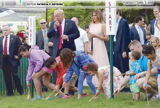  ?? AP ?? US President Donald Trump, accompanie­d by First Lady Melania Trump, blows a whistle to begin an Easter Egg Roll race at the White House on Sunday.