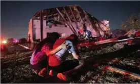  ?? Photograph: Jeffrey McWhorter/AP ?? Henry Ramirez and his mother Maribel Morales survey severe damage to their church after a tornado tore through North Dallas on Sunday.