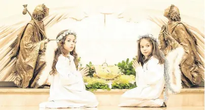  ?? PHOTO: AFP/ ARMEND NIMANI ?? Keep the faith: Kosovar children dressed as angels at the Mother Teresa cathedral in Pristina on Christmas Eve.